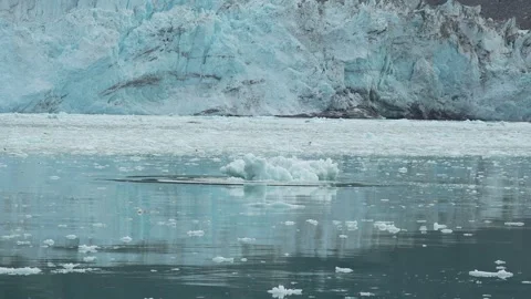 Small Ice Floe Reflected Before Eqi Glacier in Greenland 動画素材 345578010