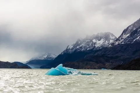 Small iceberg floating during low tide in Glacier Gray, beautiful mountain ra Stock Photos