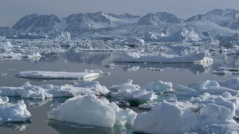 Small iceberg pieces floating on ocean water surface during day time Stock Footage 121575992