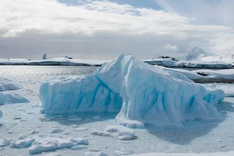 Small iceberg in the Strait between the islands off the west coast of the A.. Stock Photos