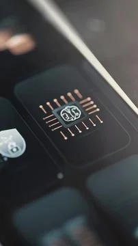 Small illuminated brain sits on a dark processor surrounded by evenly spaced Stock Photos