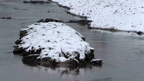 Small island created in a stream named Lauter during renaturation, snow-covered Stock Footage 99873998