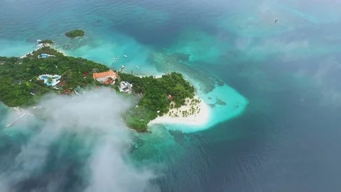 A small island in the middle of the ocean a little rain Stock Footage 72148917
