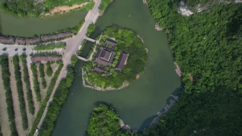 A small island surrounded by trees in the middle of a lake seen from above Nin Stock Footage 274313531