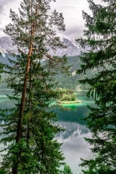 Small islands with pine-trees in the middle of Eibsee lake with Zugspitze mou Photos