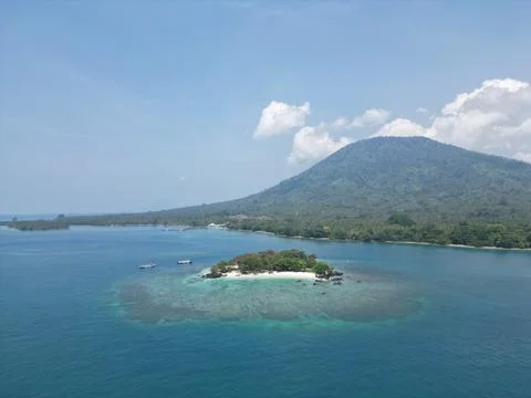 Small Islet with Sebesi Mountain Backdrop Aerial View Stock Photos