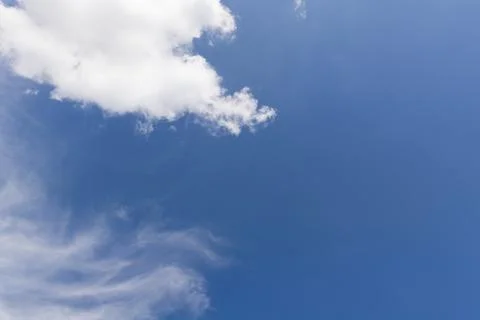 Small Isolated White Cloud in a Deep Blue Daylight Sky Stock Photos