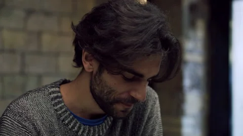 In a small Italian cafe, a thoughtful scruffy man sits and drinks his espresso c Video stock 199459093