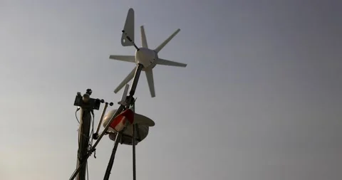 Small italian flag waving on the wind with a windmill on a mast of a boat slo Stock Footage 150202679