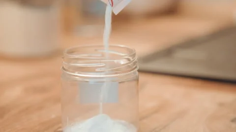 Small jar with measured spice. Precise portion of powder in glass jar. Detailed Stock Footage 342335785