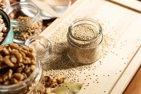 Small jar with quinoa on rustic table top view. Healthy food and snack. Stock Photos