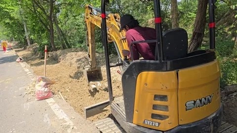 Small JCB Doing Big Work in Rural India Stock Footage 313571624