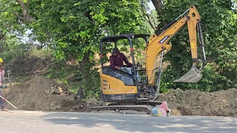 Small JCB at Work in Village Area Stock Footage 313571539