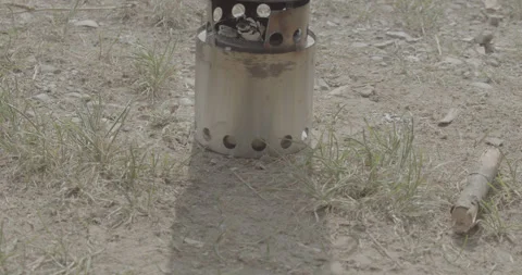 Small kettle fire, camping, rocket stove, panning up Stock Footage 150754145