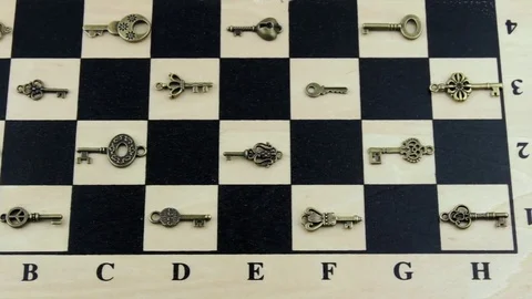 Small keys on a chessboard Stock Footage 79640009