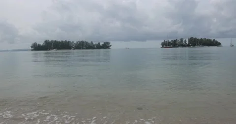 Small keys island ocean bonusing wave water treeline boats Stock Footage 204140864