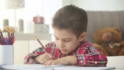 Small kid boy draw with crayons and color pictures on paper with enthusiasm Stock Footage 78199684
