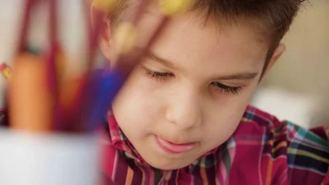 Small kid boy draw with crayons and color pictures on paper with enthusiasm Stock Footage 78200519