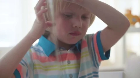 Small kid boy opens and examines book with colorful illustrations with bright Video stock 78611086