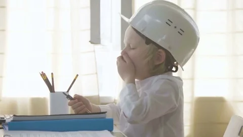 Small kid boy in white helmet imitates constructor working and busy man Stock Footage 78056718