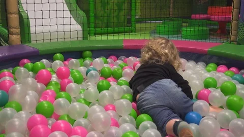 Small kid playing in ball pit Stock Footage 123430599