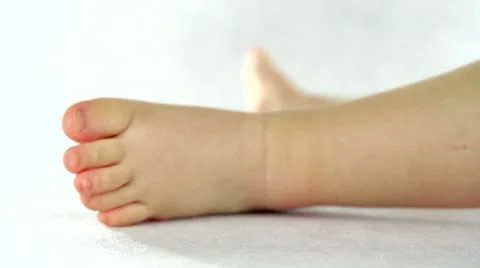 Small kid playing with legs and toes Video stock 21891533