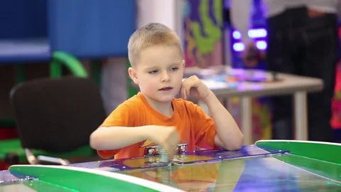 Small kid playing video arcade game Stock Footage 76877912