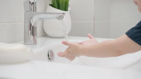 Small Kid washes hands with soap over the sink. Coronavirus pandemic prevention Stock Footage 130417671