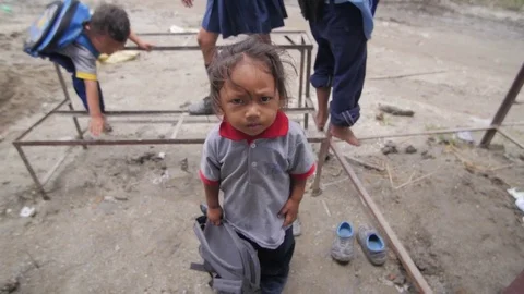 Small kid watching the camera suspiciously Stock Footage 75887780