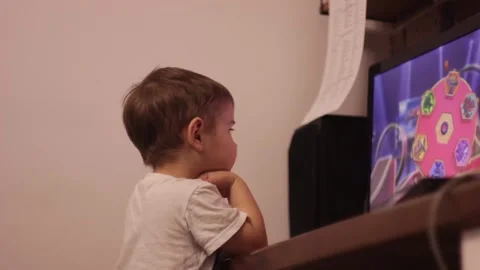 Small kid is watching cartoons at the computer at home Stock Footage 148526812