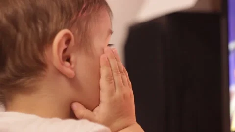 Small kid is watching cartoons at the computer at home Stock Footage 148527055