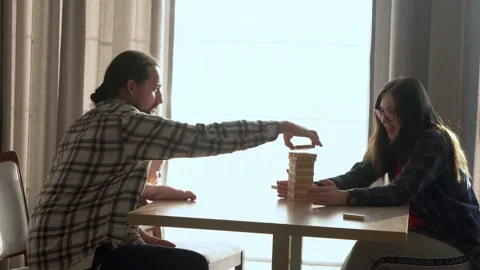 Small Kids Children playing tiny jenga with her parents at table, jenga tower Stock Footage 172419280