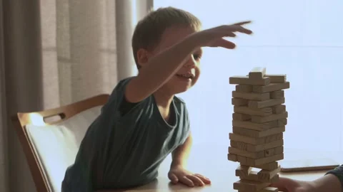 Small Kids Children playing tiny jenga with her parents at table, jenga tower Stock Footage 172505181