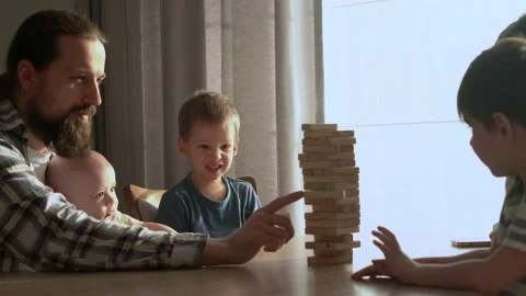 Small Kids Children playing tiny jenga with her parents at table, jenga tower Stock Footage 172756951