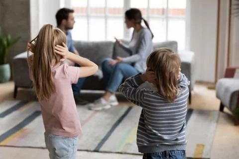 Small kids close ears avoid listening to parents fight Stock Photos