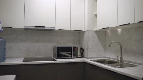 Small kitchen with cozy dinner zone in light colors Video stock 264755892