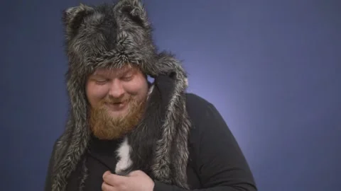 A small kitten climbs onto the shoulders of a bearded man Stock Footage 144600714