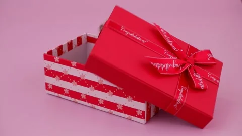 Small kitten in red gift box on pink Stock Footage 263091882