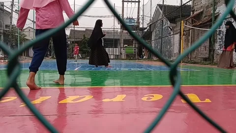 A small ladies wearing a hijab while playing ball Stock Footage 236774840