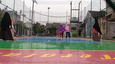 A small ladies wearing a hijab while playing ball Stock Footage 236774886