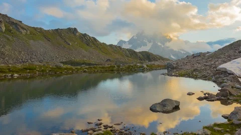 Small lake among a mountain in a clouds at the sunset, 4K time lapse scene Video stock 117240798
