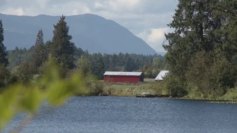 Small lake with barn in distance Video stock 75239365