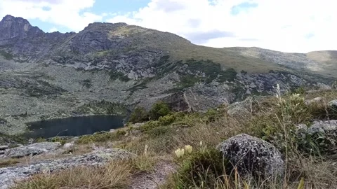 A small lake at the foot of a mountain range. Stock Footage 237903581