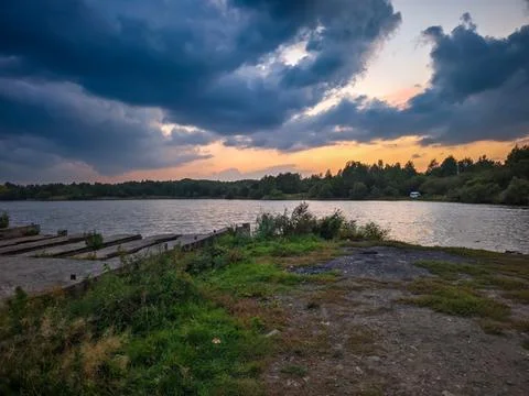 A small lake at sunset with a dramatic bright sky Stock Photos