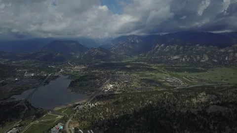 Small lake is surrounded by trees and mountains Stock-Footage 162403925