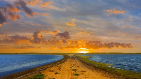 Small lakes in prairie at the dramatic sunset Vídeos de archivo 331002656