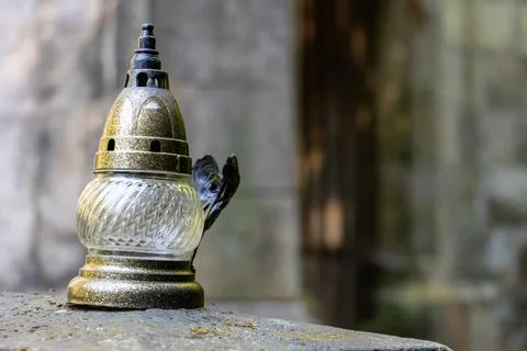 A small lamp in front of the Pseudo-Gothic chapel with a tomb in the cemetery Stock Photos