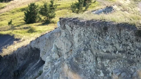 Small landslide eroding a grassy cliff edge Stock Footage 344877288