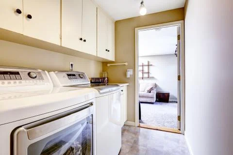 Small laundry area with cabinets Stock Photos
