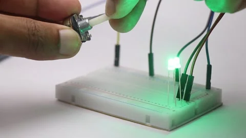 Small LED with jumper cable connected on a breadboard Video stock 318730783